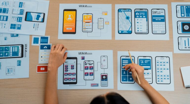 Panorama banner of startup company employee planning on user interface. Synergic Top view panorama banner of startup company employee planning on user interface prototype for mobile application or website in office. UX UI designer brainstorm user friendly interface plan. Synergic