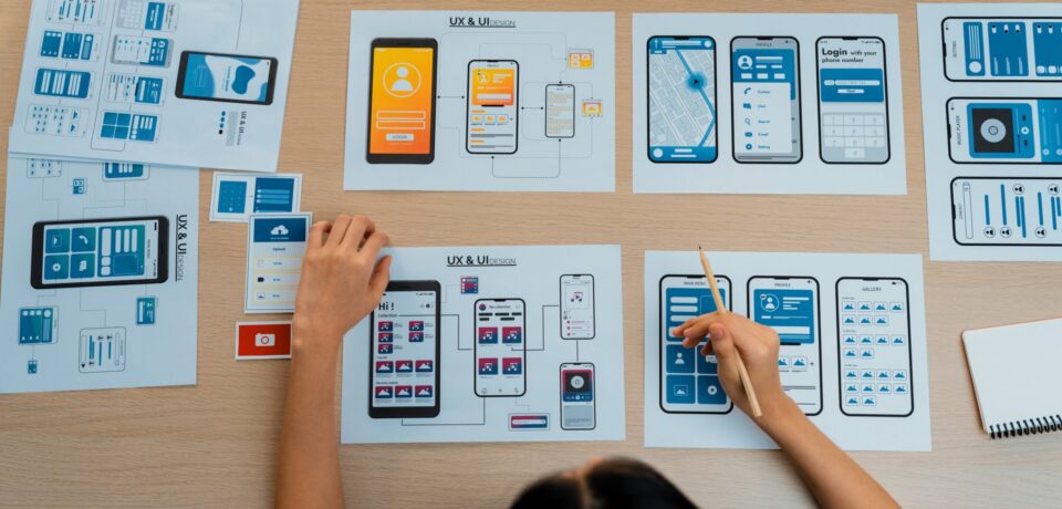 Top view panorama banner of startup company employee planning on user interface prototype for mobile application or website in office. UX UI designer brainstorm user friendly interface plan. Synergic