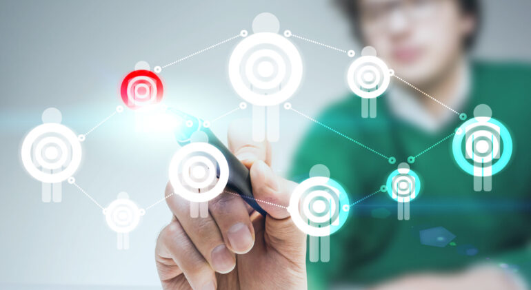 Targeting concept with red dartboard Targeting concept with young blurry man drawing red dartboard on human icon network