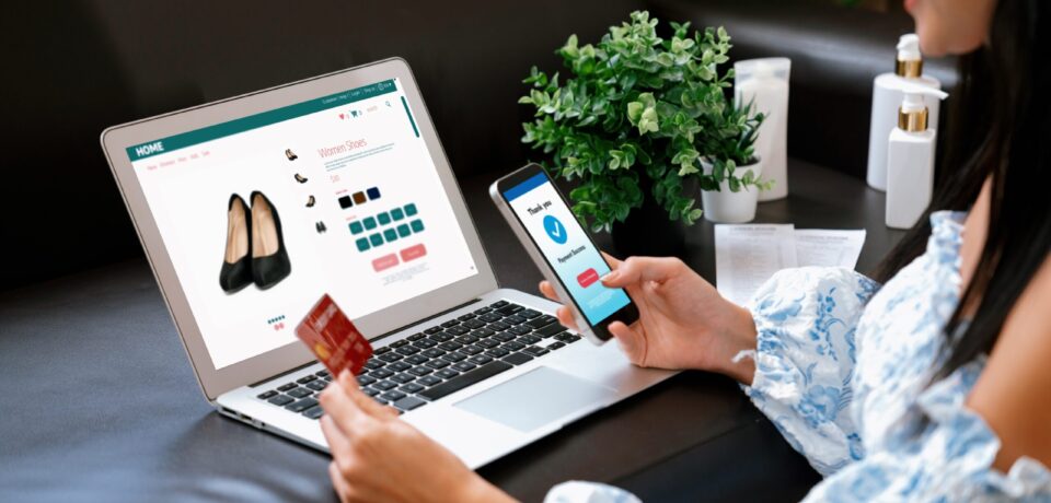Young woman order or purchase product on internet using laptop and make transaction payment by smartphone. Online shopping lifestyle with credit card via internet banking on mobile application. Blithe